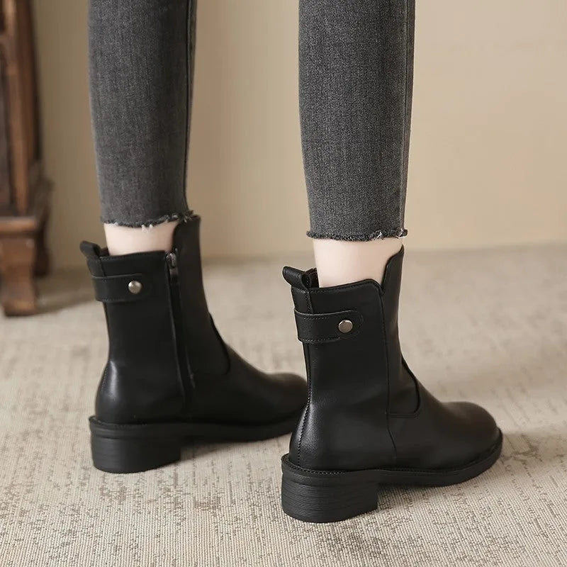 Black women's low heel ankle boots with a side zip and round toe.