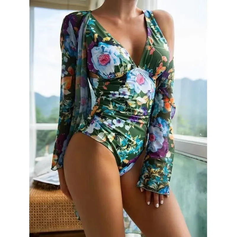 Women's floral patterned bikini three-piece set with a matching coat on a hanger