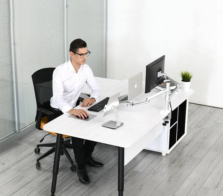 Silver foldable aluminium phone and tablet holder on a desk, showing 360-degree rotation feature.