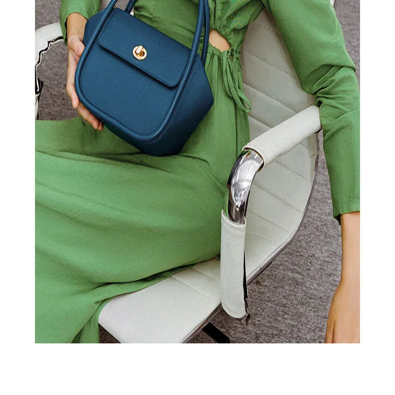 Women's leather cross-body wing bag with buckle closure in four colour options