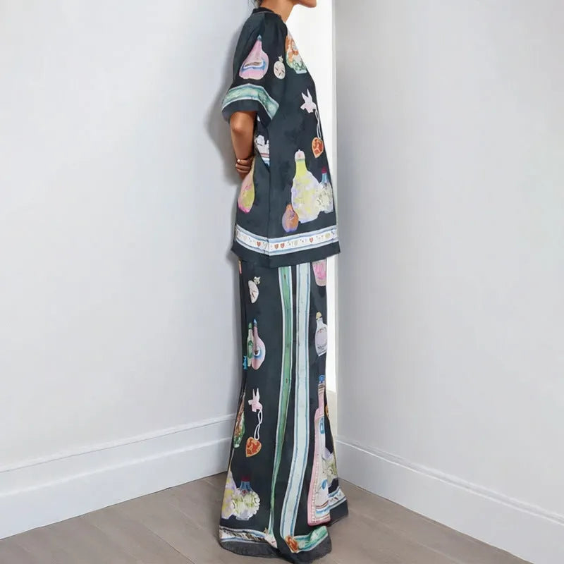 Women's black casual matching set with cartoon animation print, featuring a cardigan sleeve top and trousers