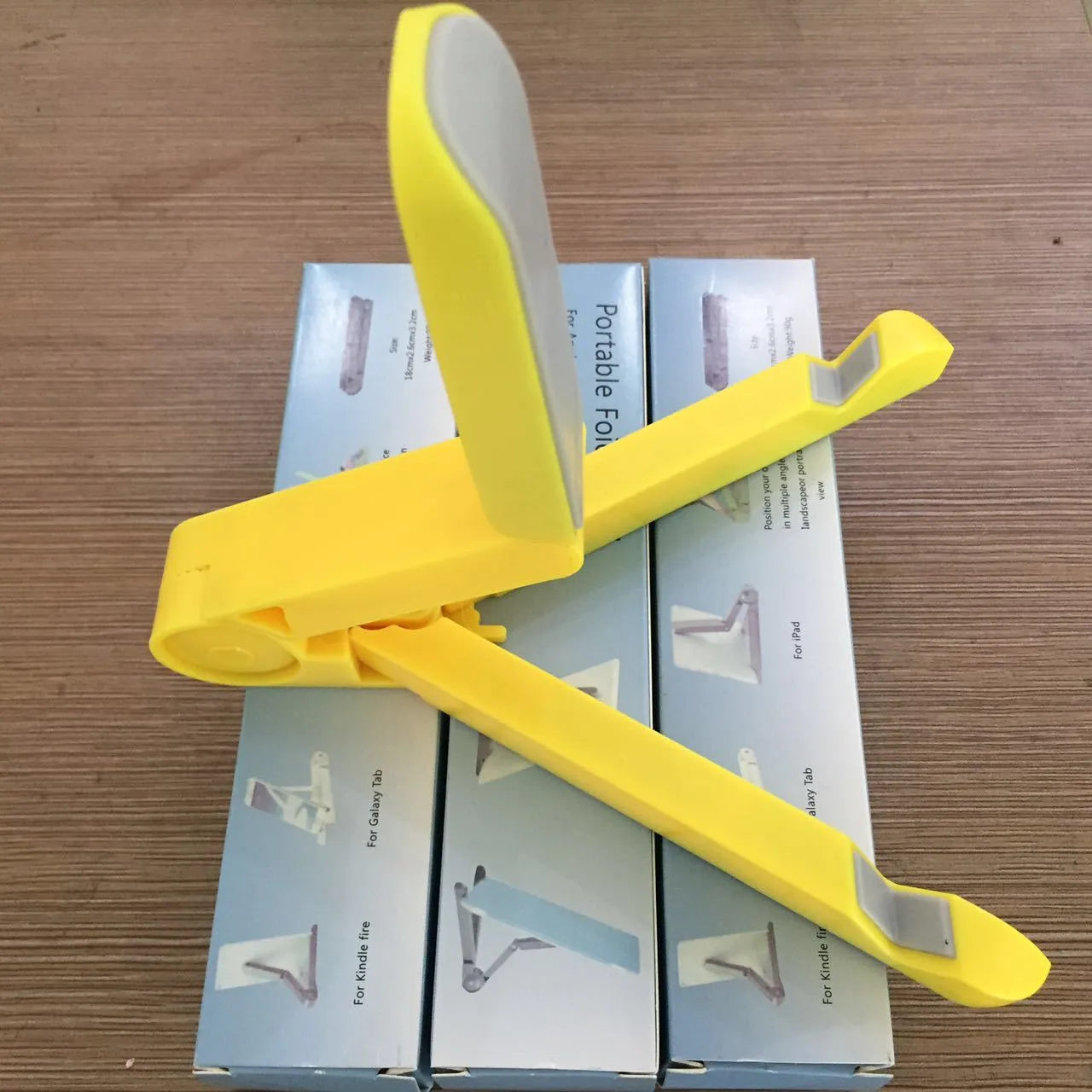 Black foldable tablet holder displaying smartphone at adjustable angle on desk