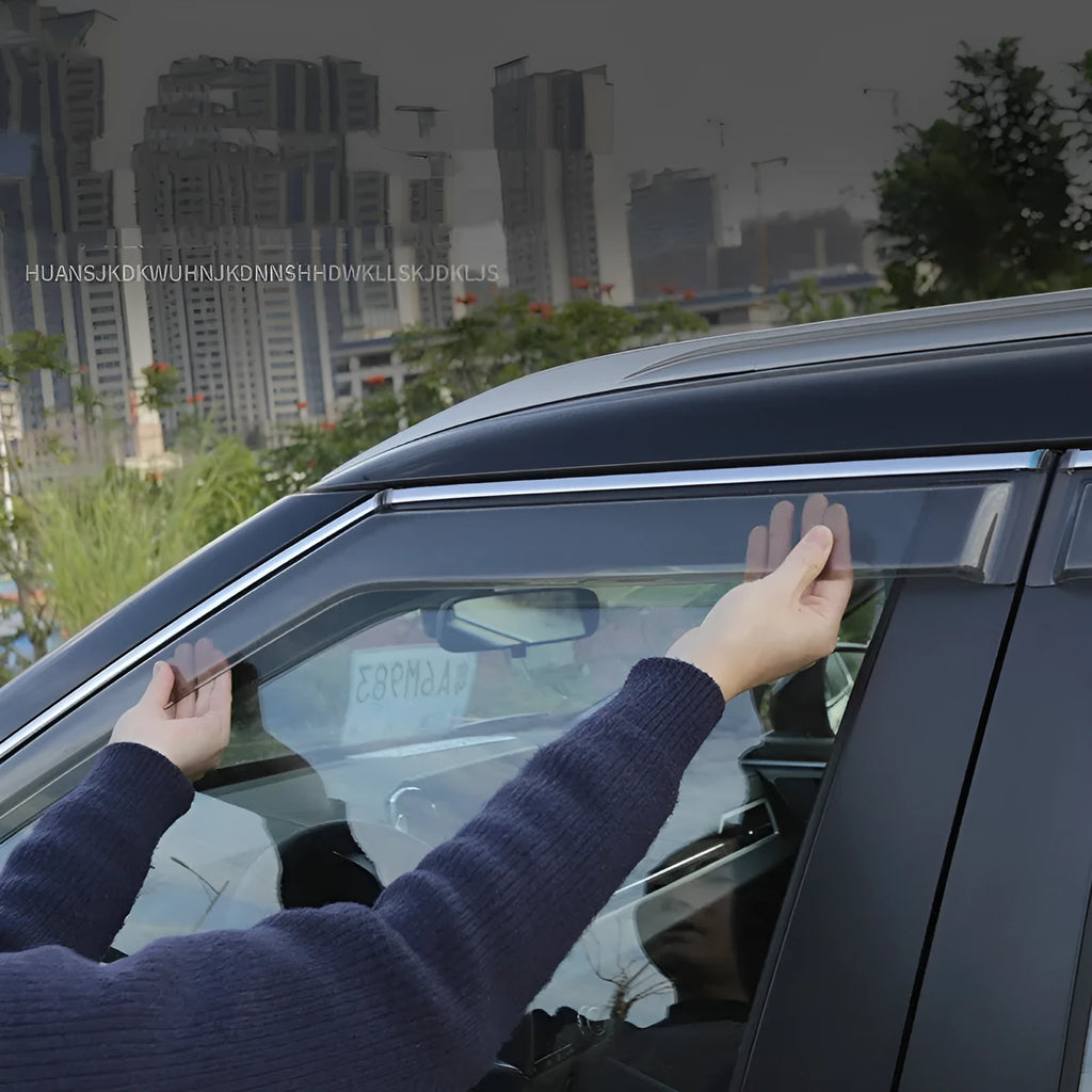 Black engineering plastic window deflectors installed on a silver 2023 Mitsubishi Outlander SUV side windows.