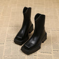 Black square toe platform Martin boots for women with a back zipper and mid-calf shaft.