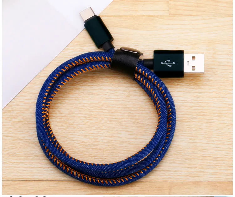 Close-up of a denim-braided USB-C cable with aluminium connectors in choice of colours.