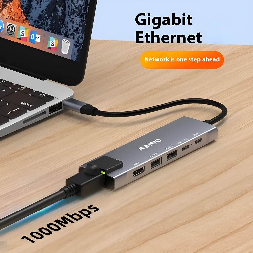 Steam Deck six-in-one aluminium docking station with HDMI, USB, and ethernet ports on a desk.
