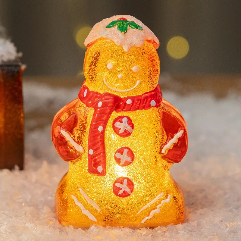 Set of four glowing plastic Christmas ornaments: gingerbread men and snowmen with red, white, and transparent scarves.