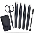 Black leather case containing six piece stainless steel eyebrow tweezers set with curved scissors and brush