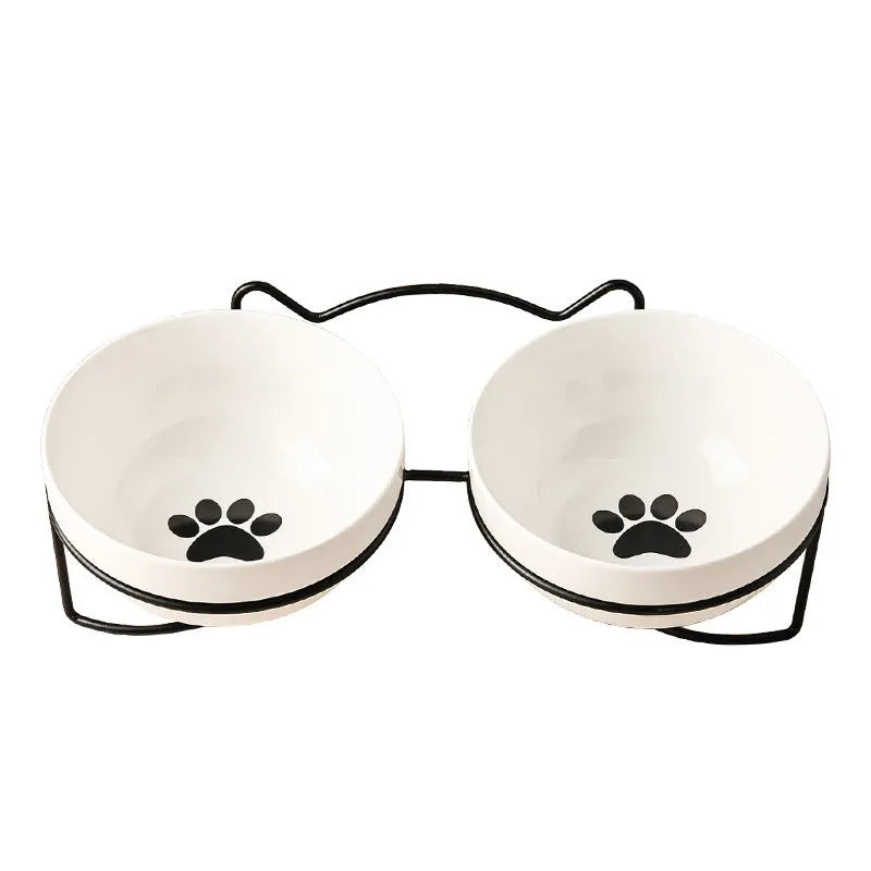 White ceramic cat bowl with decorative iron frame in cat footprints pattern