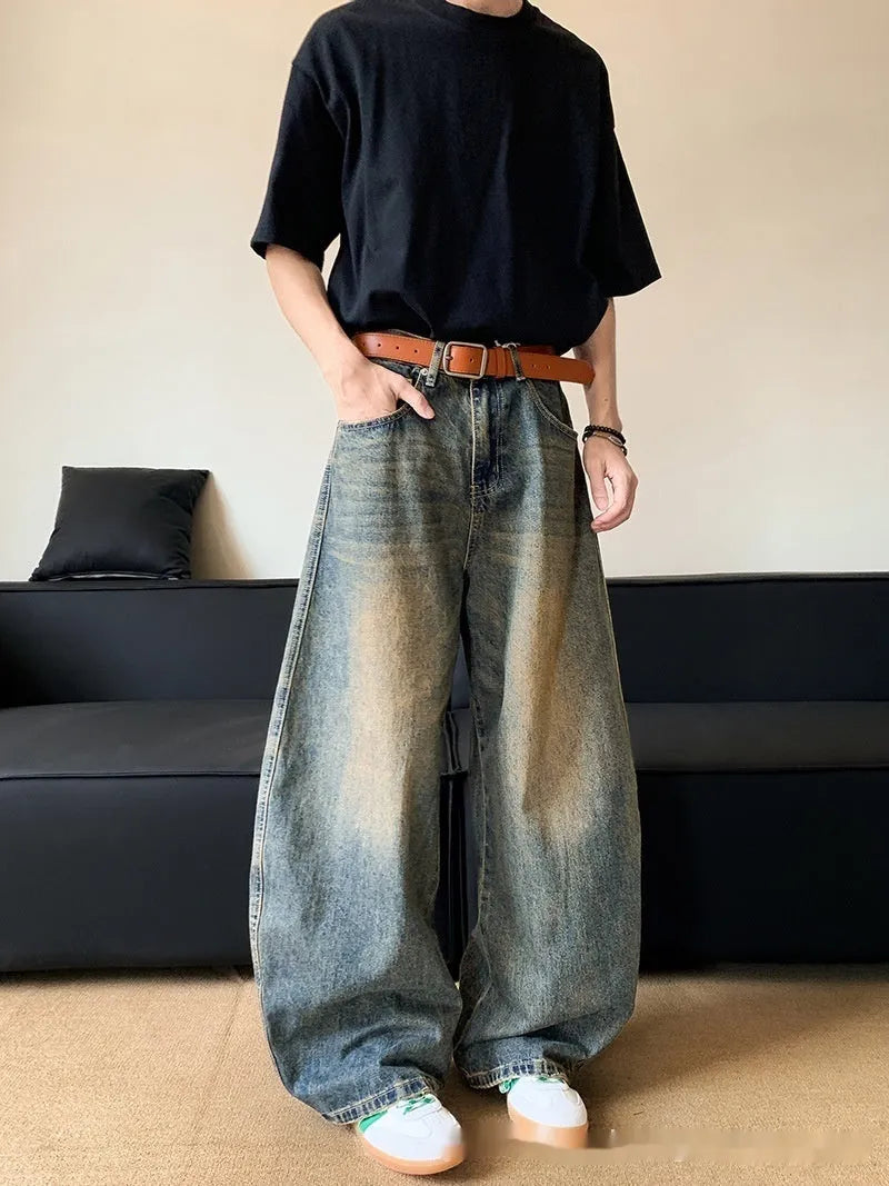 Men's retro blue distressed denim wide-leg trousers showing distressed detailing and wide-leg silhouette