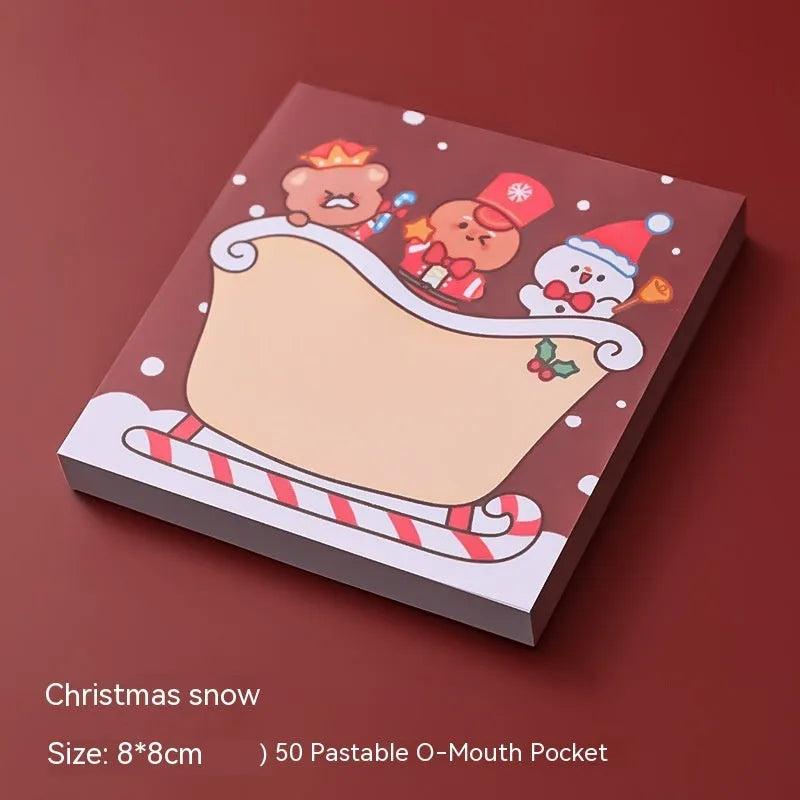 Christmas sticky notes book with cartoon designs of Santa, snowman, elf, gift, house, sled, crystal ball, and bear
