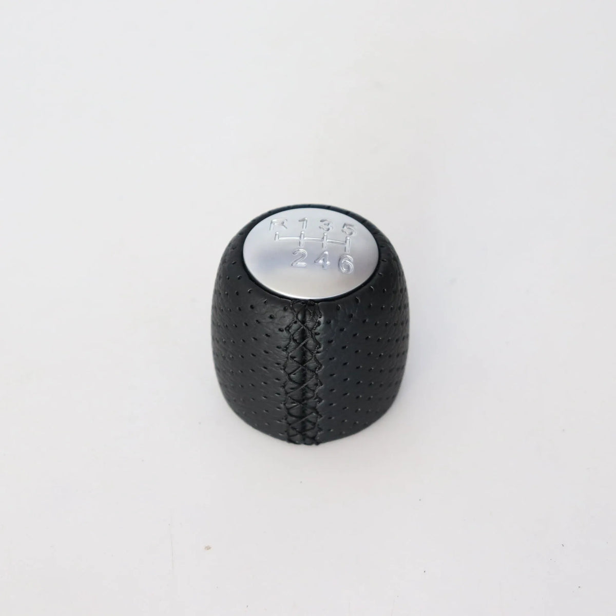 Black perforated leather-style gear shift knob for Alpha car on a 5-speed pattern matte cover.