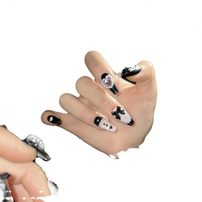 Black detachable manicure set with hand-painted pink hearts and bow patterns in cat eye style