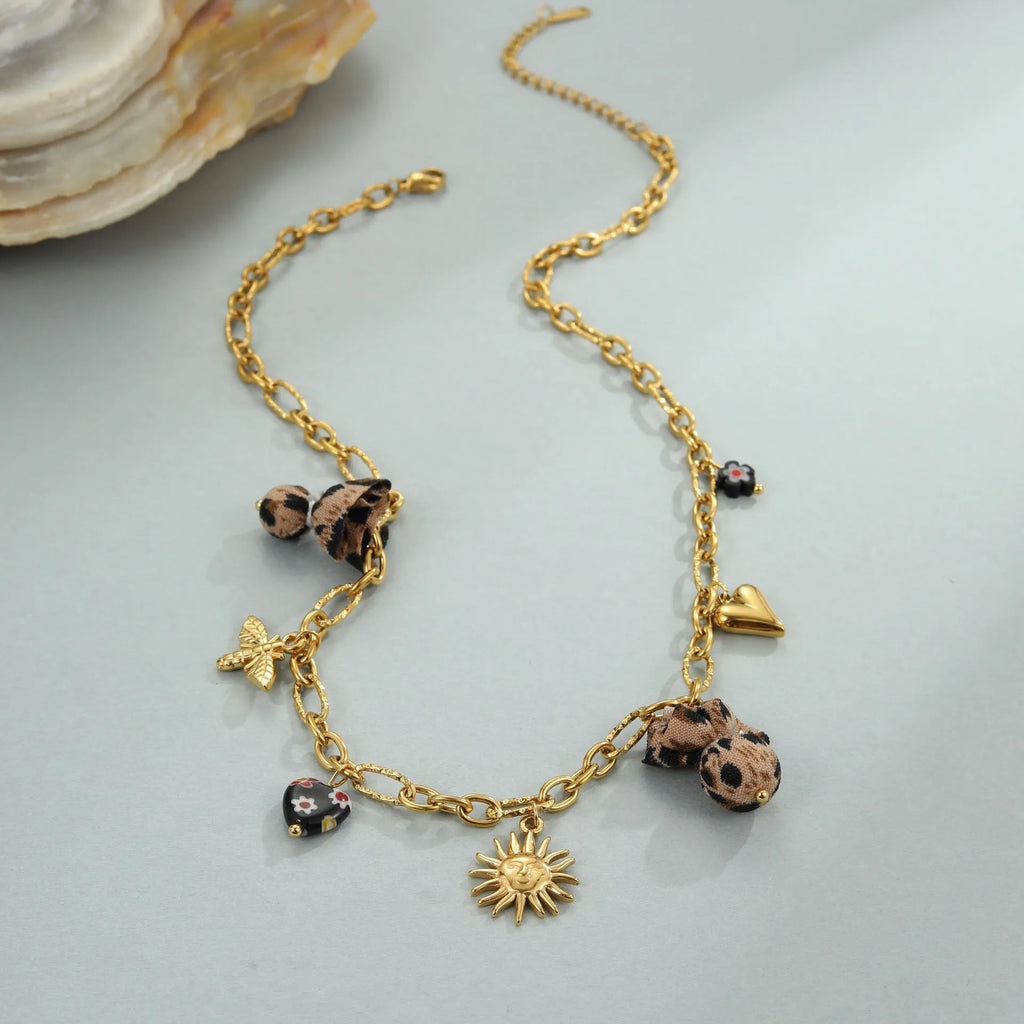 Stainless steel necklace with gold electroplated leopard pendant featuring love heart flowers on geometric design