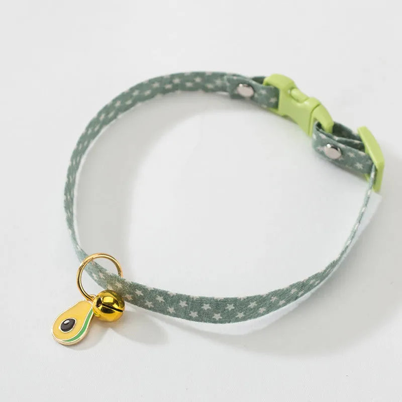 Green adjustable pet collar with a pink bow tie and silver bell for a small dog or cat