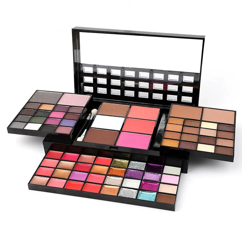 74 colour makeup palette open showing eyeshadows, lip glosses, and face powders with a mirror and brushes.