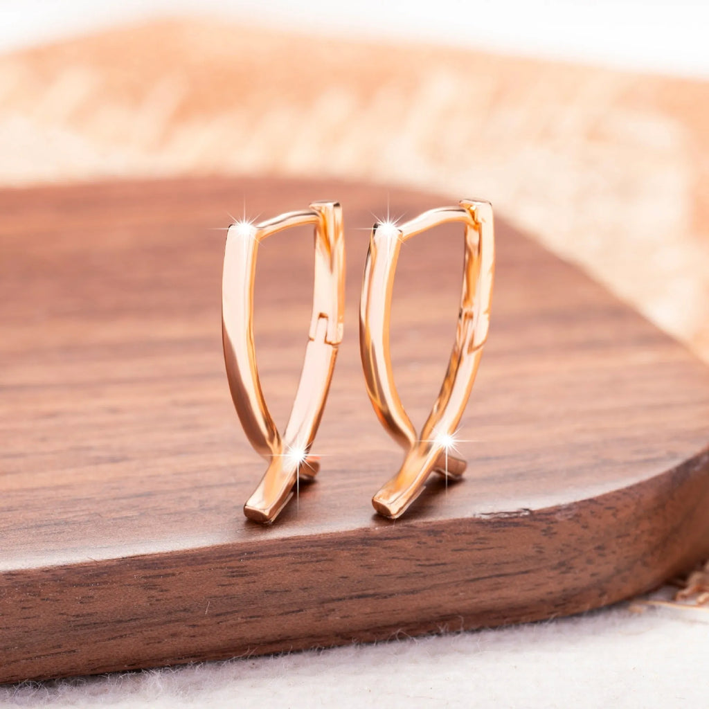 Rose gold cross shaped earrings on copper base with light luxury finish