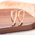 Rose gold cross shaped earrings on copper base with light luxury finish