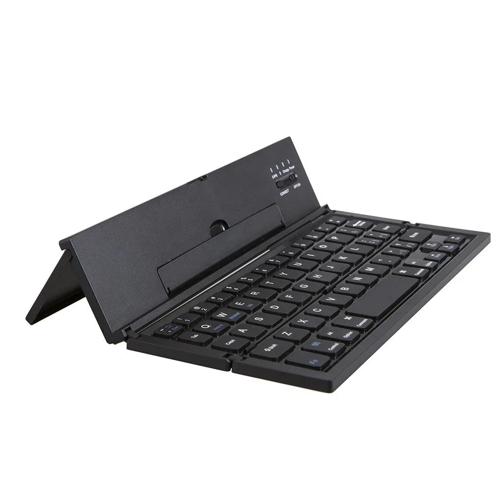 Black folding Bluetooth keyboard unfolded next to tablet showing ultra-thin design