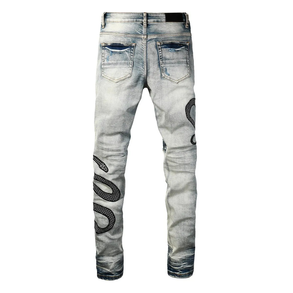 Distressed blue skinny jeans with tapered leg and button fly closure on mid-waist design