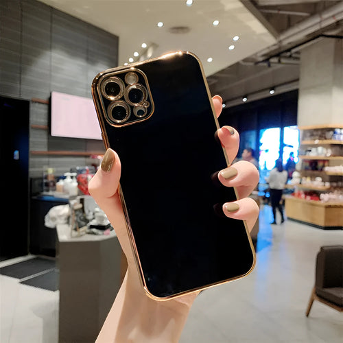 Gold plated and silicone stripe decorative case for iPhone on a solid colour background.