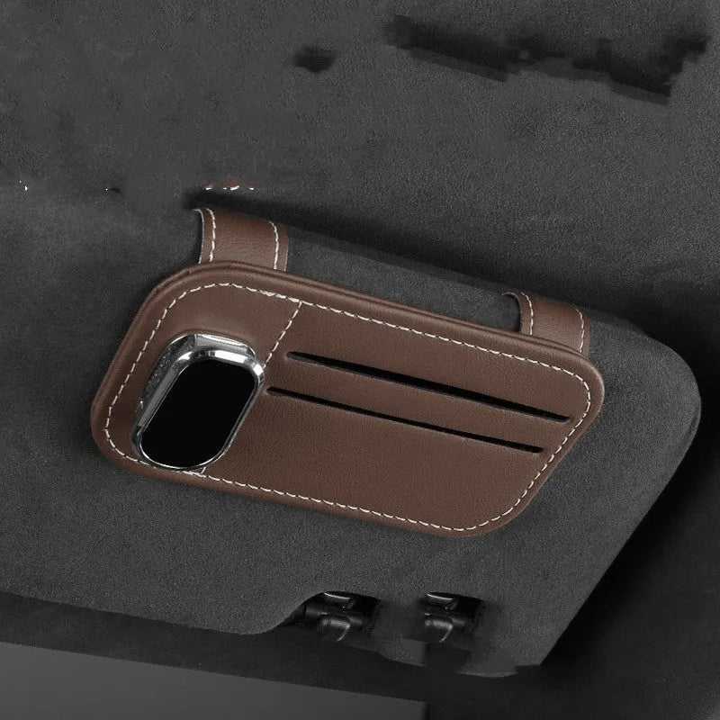 Beige cowhide leather automotive sun visor card holder with a glasses clip attached.