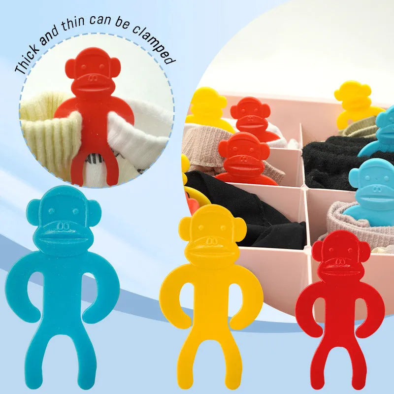 Plastic socks clips in blue, red and yellow colours for laundry organisation