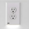 White socket induction LED night light plugged into UK wall socket with automatic sensor