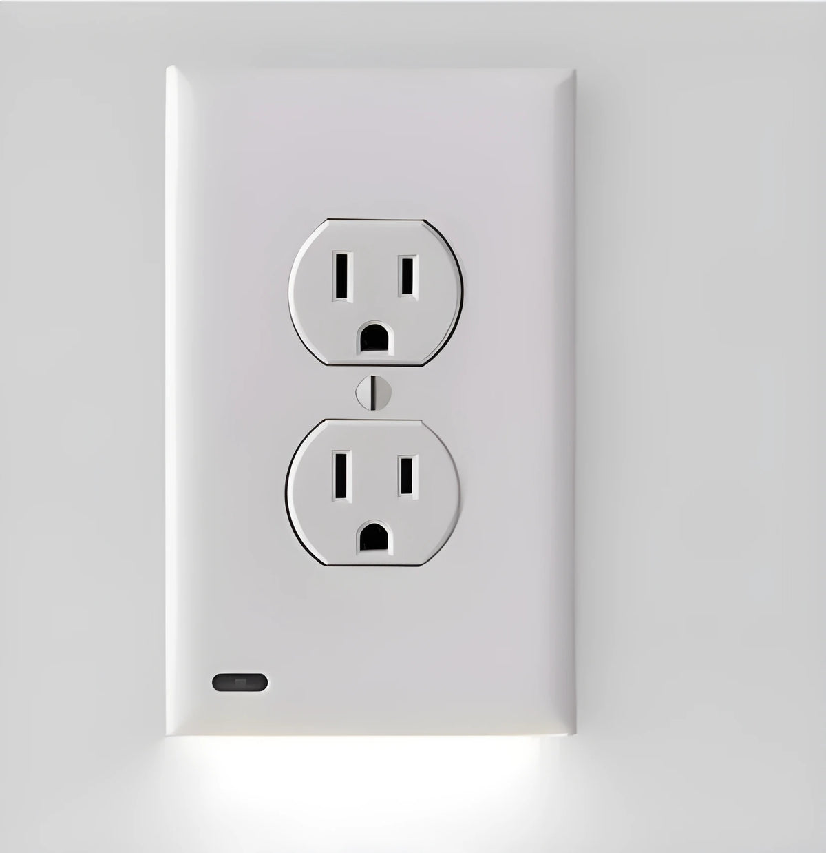 White socket induction LED night light plugged into UK wall socket with automatic sensor