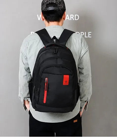 Blue Oxford fabric backpack with side zipper pockets and thick shoulder straps