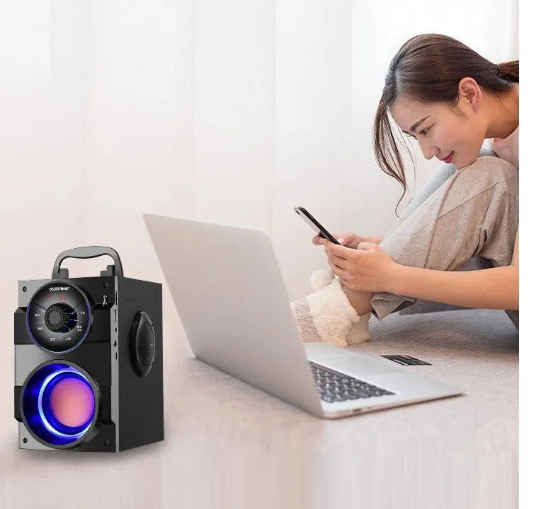 Black portable audio system with subwoofer, USB cable, and 3.5mm audio connection cable