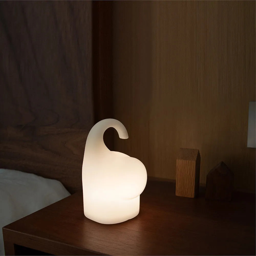 Elephant shaped silicone night light with warm 3000k LED glow on a bedside table