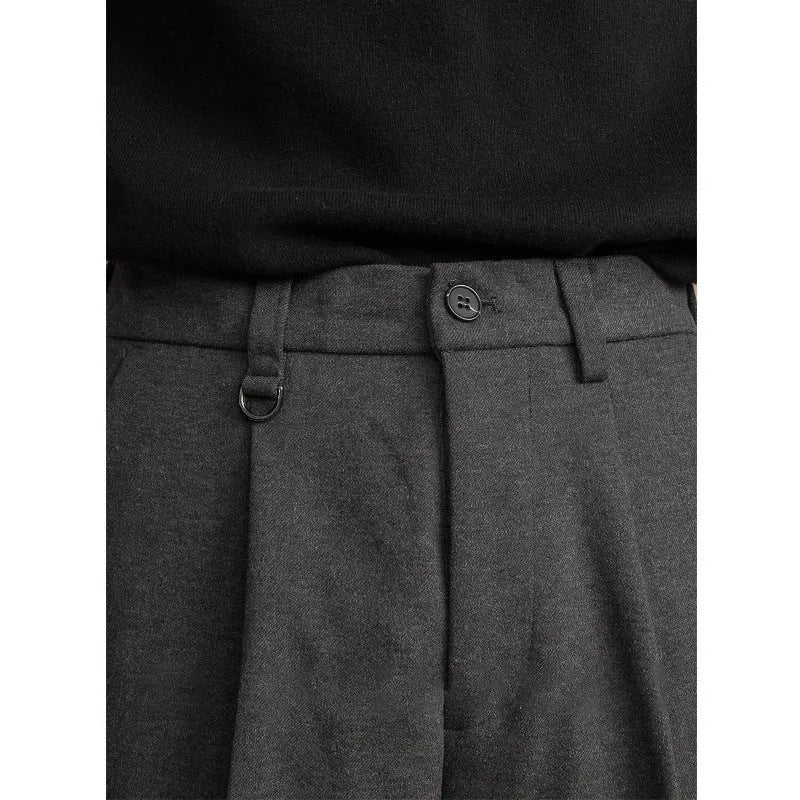 Men's straight leg casual pants in black with a draped fit, shown on a hanger.