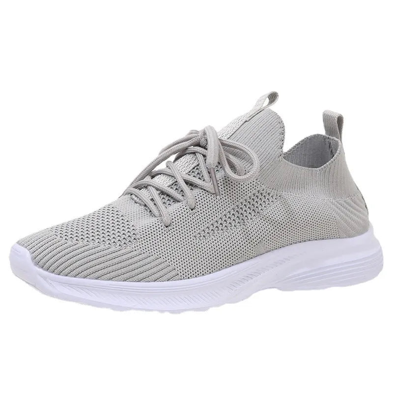 Women's mesh running shoes in creamy white with Flyknit upper and rubber sole