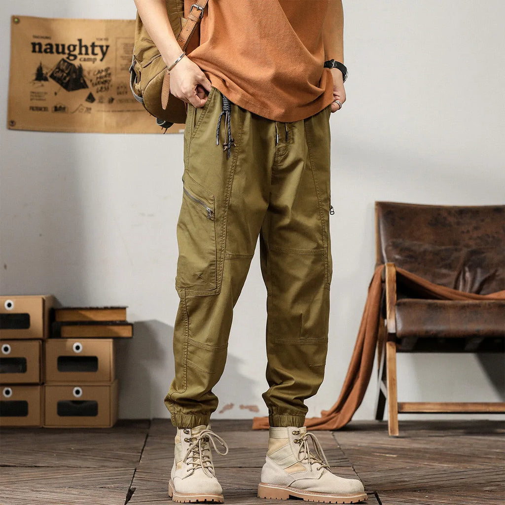 Men's khaki cotton harem pants with tapered ankle band and zip placket front view