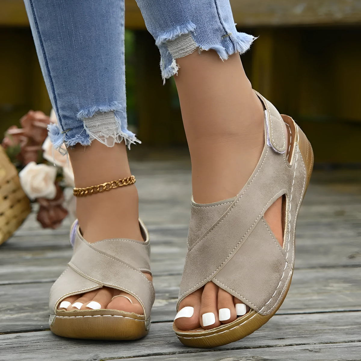 Women's brown Roman sandals with Velcro strap and platform wedge sole on a white background.