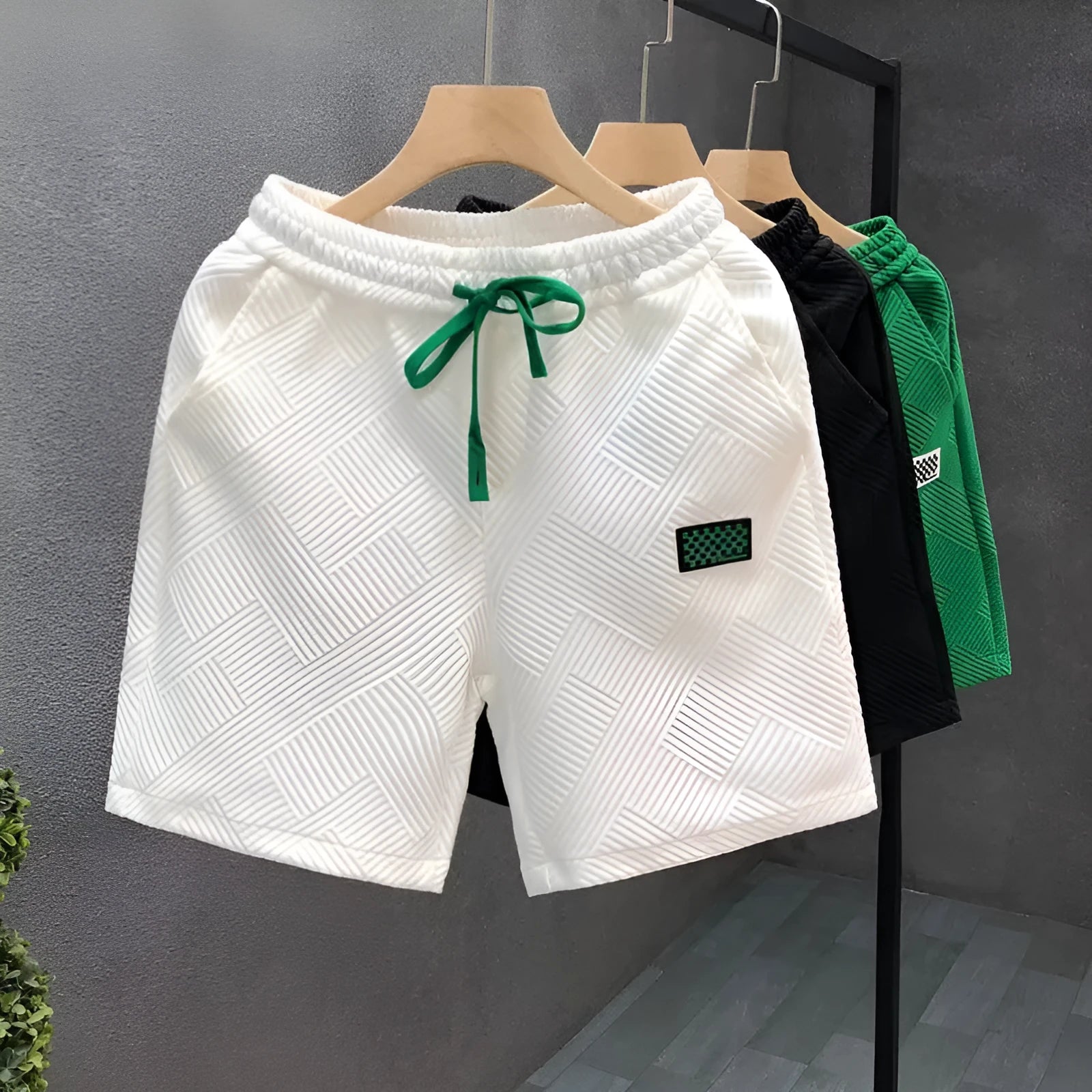 A pair of solid-colour casual sports shorts made from polyester, shown in white, suitable for beach and outdoor activities.