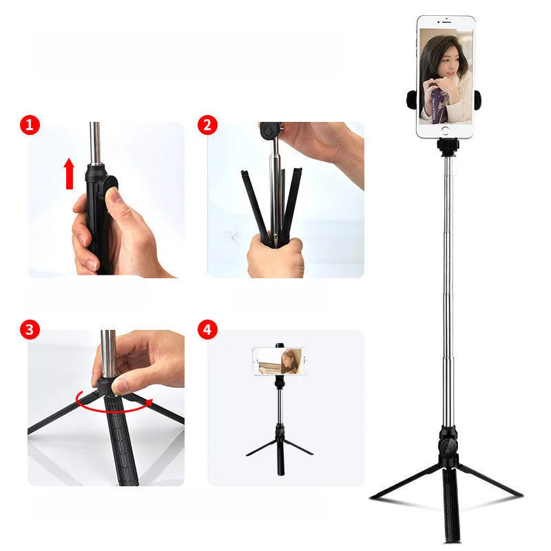 Apple-compatible black tripod selfie stand with Bluetooth remote and 360-degree rotating phone clip extended.