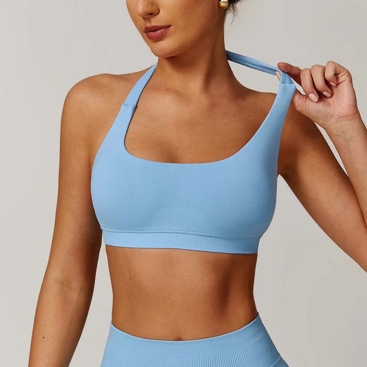 Women's black halter neck sports bra with hollow back and removable pads