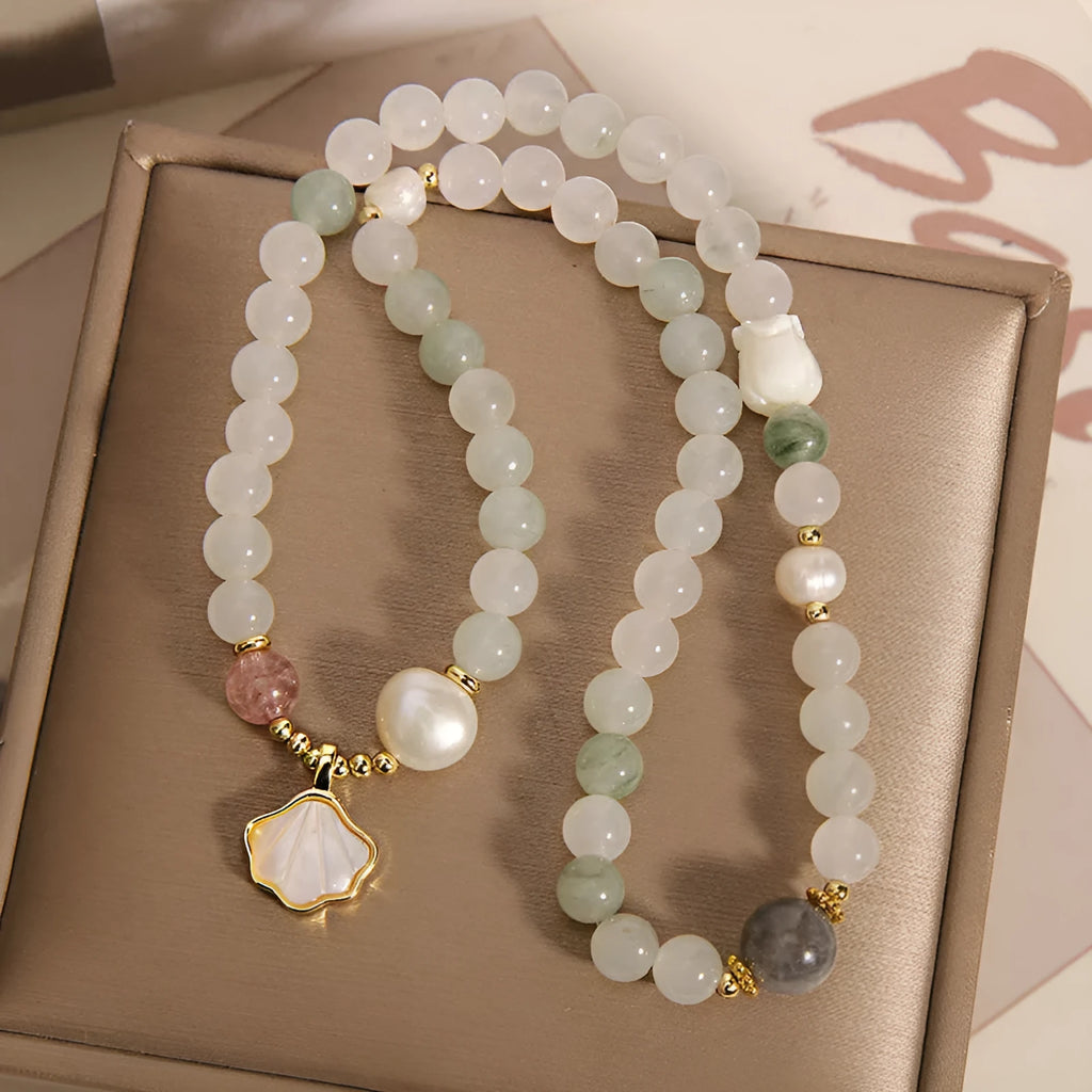 Emerald green crystal bracelet with ginkgo leaf pendant and gold-plated rhinestone details