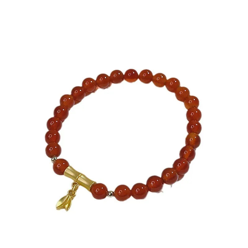 Women's red agate bracelet with Chinese dragon design, a handcrafted gift for Bamboo Festival.