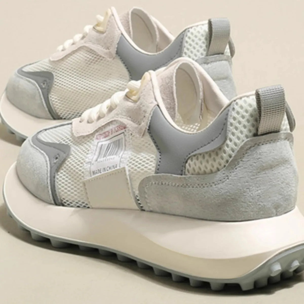 Women's grey and pink retro sneakers with low top design and rubber sole