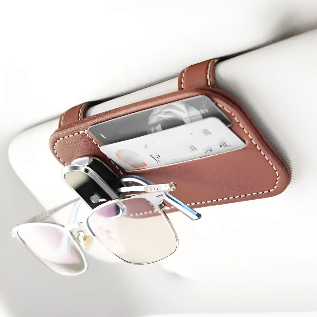 Beige cowhide leather automotive sun visor card holder with a glasses clip attached.