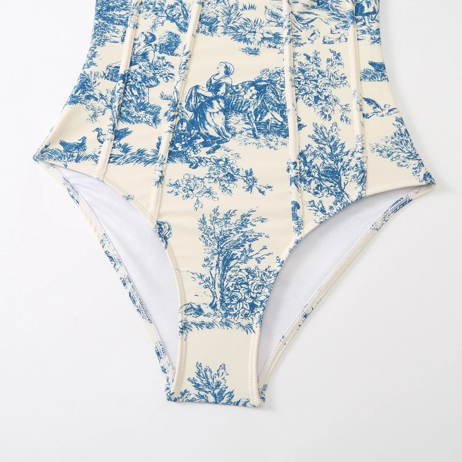 Women's patterned blue one-piece swimsuit with matching gauze skirt accessory