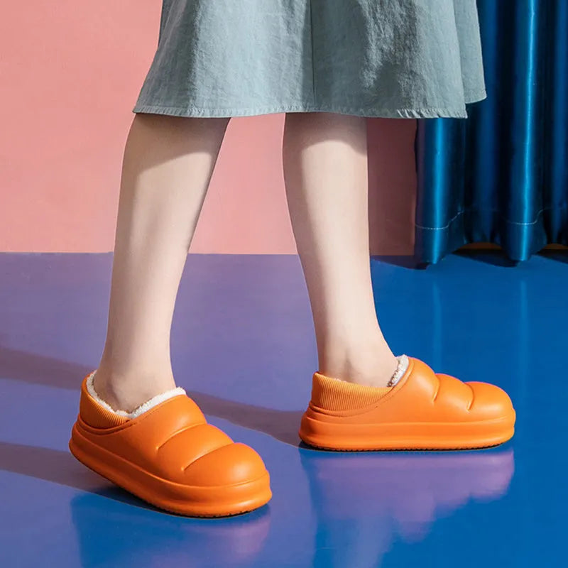 A pair of waterproof EVA couple slippers with a plush lining, shown in a choice of colours like green, pink, or grey.