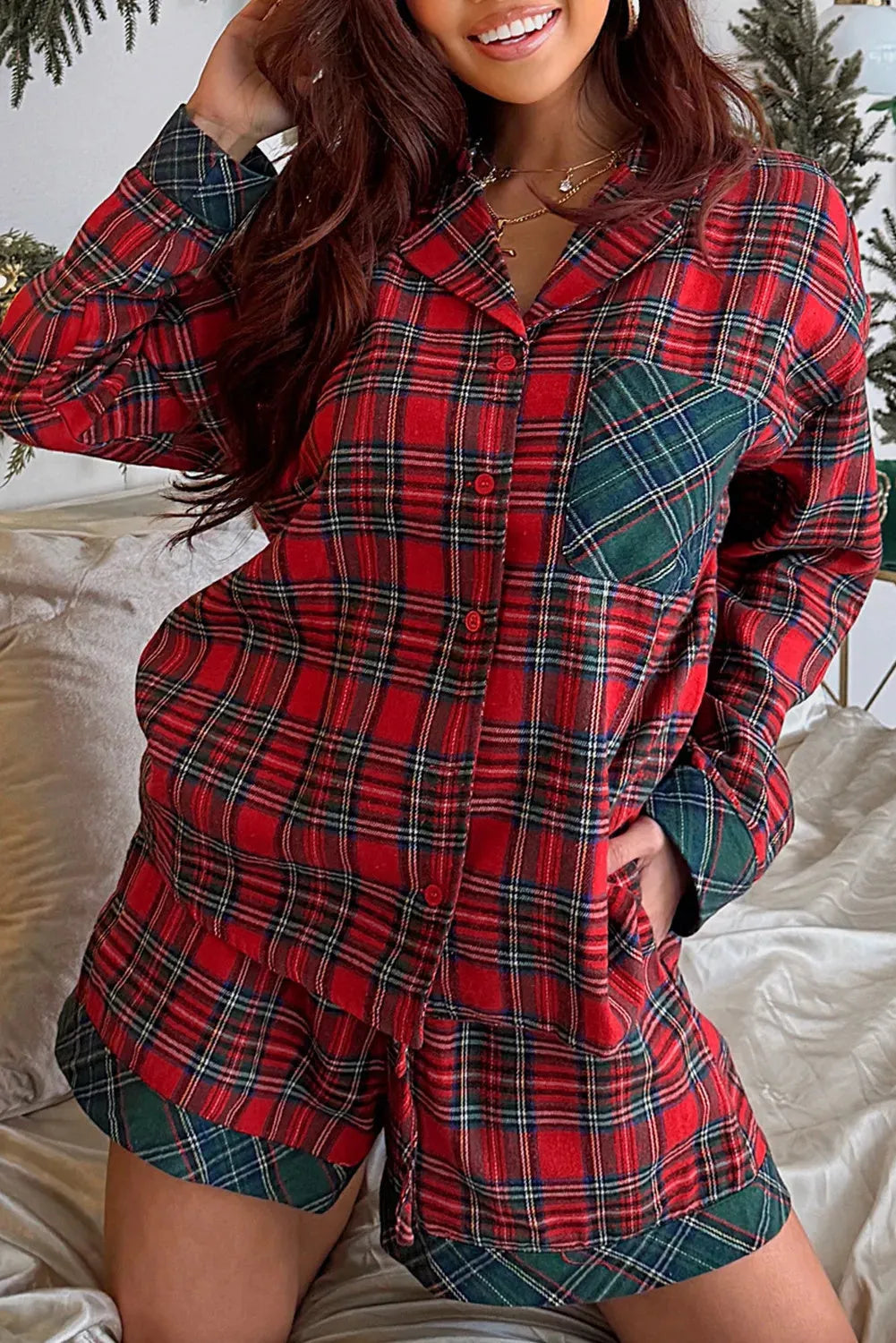 Red plaid Christmas pajama set with long sleeve shirt and shorts on hanger