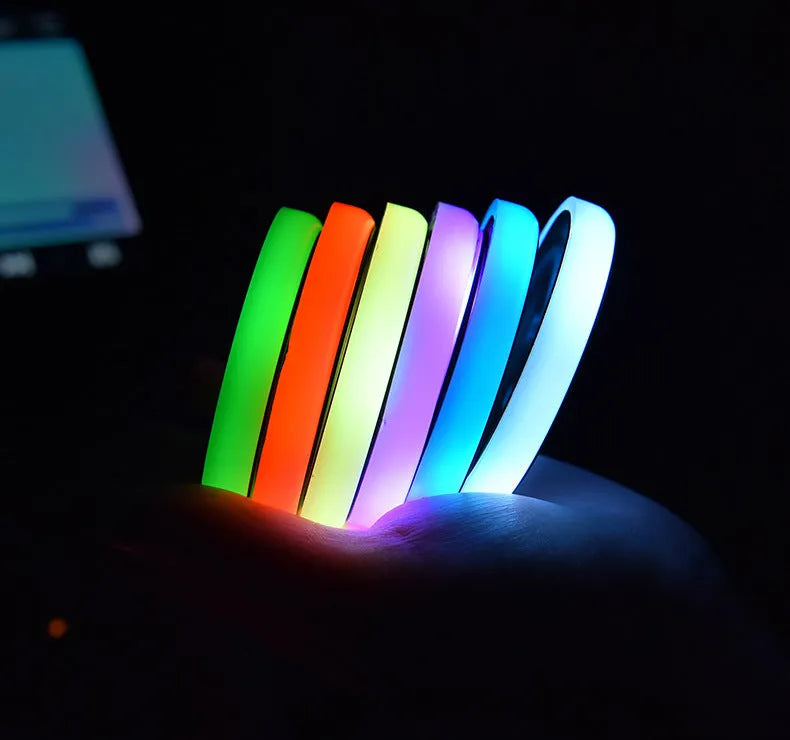 Colourful LED light-up coaster for car cup holders showing seven colour options and USB charging cable