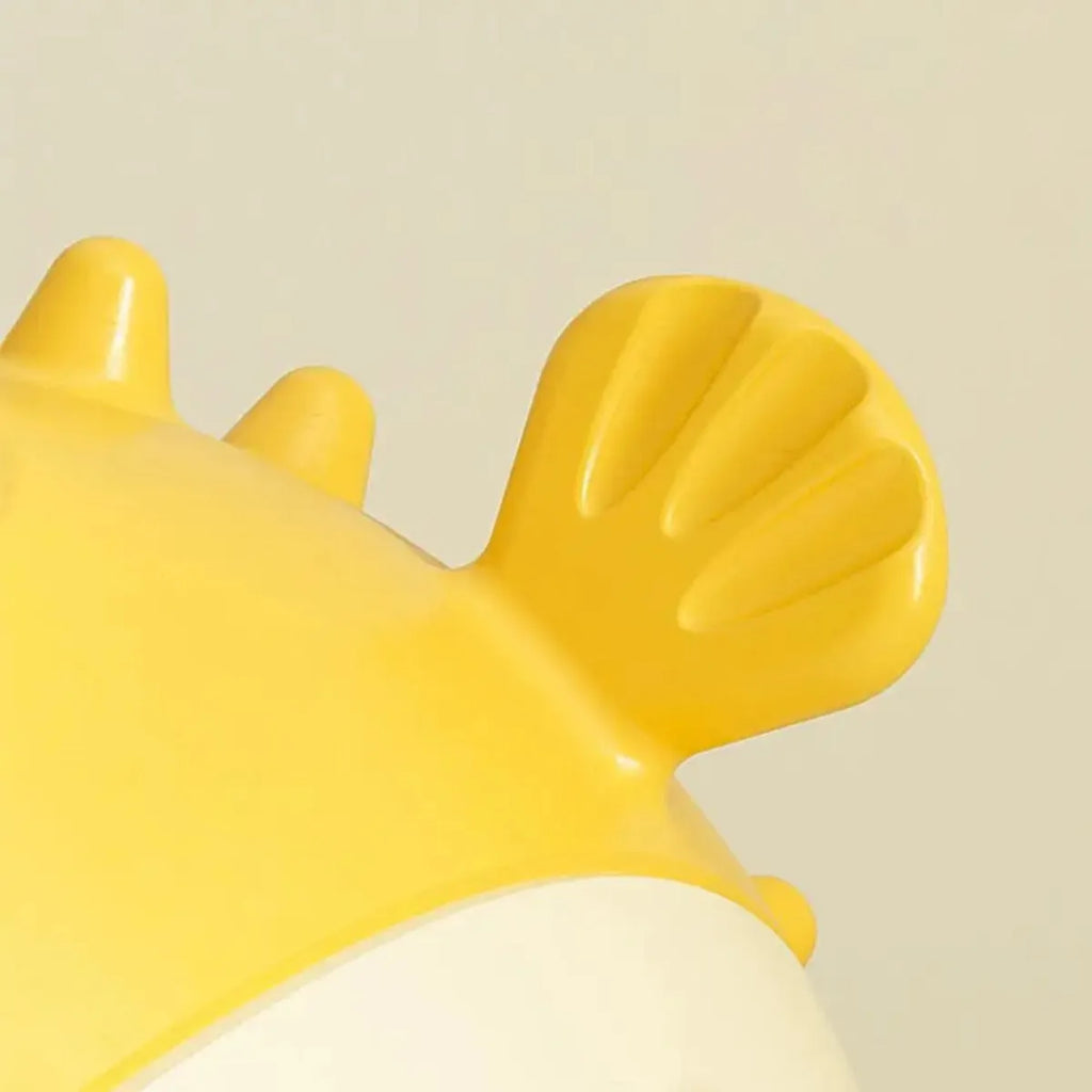 Yellow fish-shaped vinyl dog chew toy with textured surface for teeth cleaning