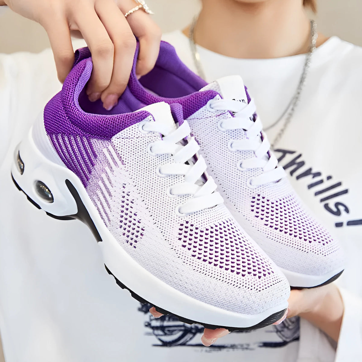 Women's pink Flyknit casual running shoes with mesh lining and flat PVC sole on a white background.