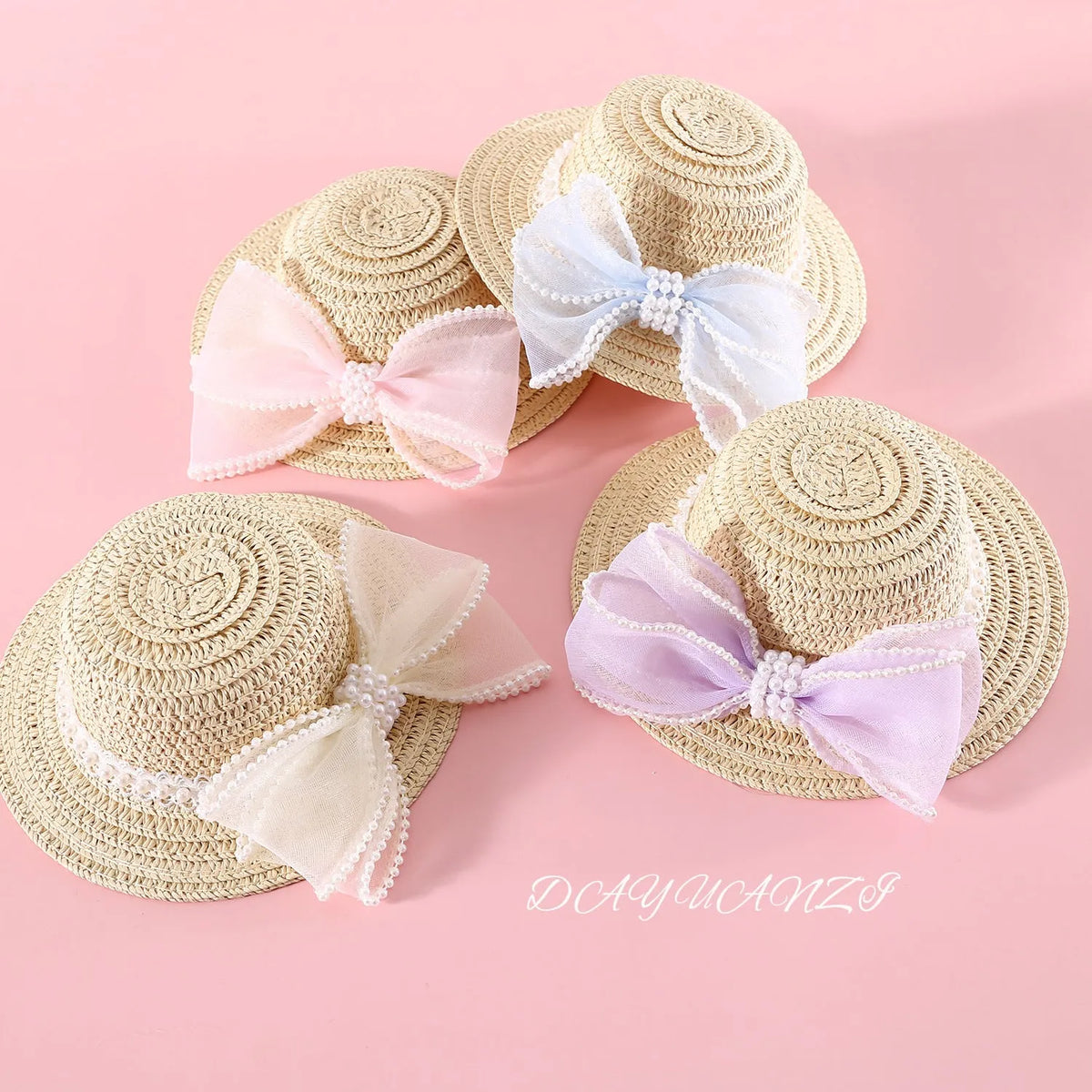 Pet cat wearing a woven Lafite leaf straw hat with a pearl butterfly decoration.